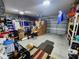 Spacious garage with storage racks, tools, bikes, and a rolling garage door at 5526 Bonn Way, St Cloud, FL 34771