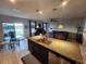Open kitchen with granite countertops, stainless steel appliances, and comfortable seating area at 5526 Bonn Way, St Cloud, FL 34771