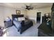 A serene main bedroom featuring a ceiling fan and dark furniture at 5526 Bonn Way, St Cloud, FL 34771
