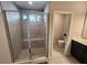 A modern bathroom featuring a tiled shower with a built-in seat and glass door is shown at 5526 Bonn Way, St Cloud, FL 34771