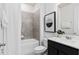 Well-lit bathroom featuring a tiled shower-tub combination, a sleek vanity, and modern fixtures at 6011 Wildline Dr, St Cloud, FL 34771