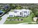 Stunning aerial view of modern property with a geometric design, lush landscaping, and a sleek, fenced perimeter at 6106 Marleon Dr, Windermere, FL 34786