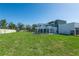 A spacious backyard featuring a modern home with a covered patio and ample green space for recreation and relaxation at 6106 Marleon Dr, Windermere, FL 34786