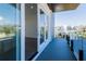 Balcony with gray floors, glass railings, and sliding glass doors to the bedroom at 6106 Marleon Dr, Windermere, FL 34786