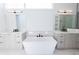 Modern bathroom with white marble floors, double sinks, and a soaking tub at 6106 Marleon Dr, Windermere, FL 34786