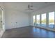 Bright bedroom with gray floors, ceiling fan, and sliding glass doors to the balcony at 6106 Marleon Dr, Windermere, FL 34786