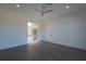 Bright bedroom with gray floors, ceiling fan, and access to the bathroom at 6106 Marleon Dr, Windermere, FL 34786