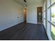 Bedroom featuring hardwood floors, an ensuite bathroom, and a large bright window at 6106 Marleon Dr, Windermere, FL 34786