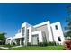 Contemporary home with striking architectural details, lush landscaping, and a welcoming entrance at 6106 Marleon Dr, Windermere, FL 34786