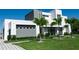 Modern two-story home with clean lines and palm trees, showcasing architectural design and manicured landscaping at 6106 Marleon Dr, Windermere, FL 34786