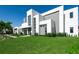 Modern two-story home with unique architectural details, large windows, and carefully maintained landscaping at 6106 Marleon Dr, Windermere, FL 34786