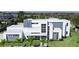 Aerial view showcasing a modern home with clean lines, lush landscaping, and a well-manicured lawn at 6106 Marleon Dr, Windermere, FL 34786