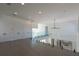 Open hallway with gray floors, glass railings, and access to the kitchen at 6106 Marleon Dr, Windermere, FL 34786