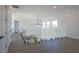 Open hallway with gray floors, glass railings, and a ceiling fan overlooking the kitchen at 6106 Marleon Dr, Windermere, FL 34786