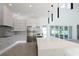 Modern kitchen boasting stainless steel appliances, a center island with a marble countertop, and stylish pendant lighting at 6106 Marleon Dr, Windermere, FL 34786