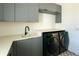 Laundry room featuring gray cabinetry, quartz countertop, and Samsung washer & dryer at 6106 Marleon Dr, Windermere, FL 34786
