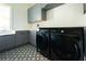 Laundry room featuring gray cabinetry, quartz countertop, and Samsung washer & dryer at 6106 Marleon Dr, Windermere, FL 34786