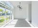 Sunlit living room with a large window, showcasing the landscape and sleek modern lighting fixture at 6106 Marleon Dr, Windermere, FL 34786