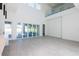 Bright living room featuring large sliding glass doors and a soaring two-story ceiling at 6106 Marleon Dr, Windermere, FL 34786