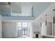 Bright living room with soaring ceilings, clerestory windows, modern lighting, and glass-lined second-floor balcony at 6106 Marleon Dr, Windermere, FL 34786