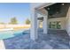 Covered patio featuring stone flooring, modern pillars, and a view of the private pool at 6106 Marleon Dr, Windermere, FL 34786