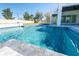 A beautiful outdoor space with a modern pool, patio, and a manicured lawn at 6106 Marleon Dr, Windermere, FL 34786