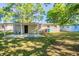 View of the backyard featuring a covered patio with an attached structure, and ample greenery at 616 Conroy St, Orlando, FL 32805