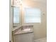 Bathroom features a granite countertop, mirror, and a window with blinds at 616 Conroy St, Orlando, FL 32805