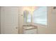 Bathroom featuring a granite countertop, white cabinets, and a window at 616 Conroy St, Orlando, FL 32805