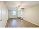 Bedroom with a ceiling fan, wood-look floors, and a nearby door at 616 Conroy St, Orlando, FL 32805