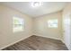 Bedroom showcasing natural light and sleek, wood-look flooring for a modern and inviting atmosphere at 616 Conroy St, Orlando, FL 32805