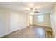 Sunlit bedroom features wood-look vinyl flooring, ceiling fan, and a walk-in closet at 616 Conroy St, Orlando, FL 32805