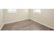 Bedroom featuring neutral walls, wood-look flooring, and windows providing ample natural light at 616 Conroy St, Orlando, FL 32805