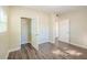 Bedroom featuring a spacious closet, neutral walls, and sleek wood-look floors at 616 Conroy St, Orlando, FL 32805