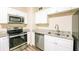 Updated kitchen features granite countertops, stainless steel appliances, and modern finishes at 616 Conroy St, Orlando, FL 32805