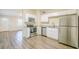 Kitchen features stainless steel appliances, granite counters, and wood-look vinyl flooring at 616 Conroy St, Orlando, FL 32805