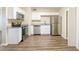 Bright kitchen with stainless steel appliances, granite countertops and wood-look vinyl flooring at 616 Conroy St, Orlando, FL 32805