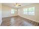 Welcoming living room with laminate floors, windows, and light paint at 616 Conroy St, Orlando, FL 32805
