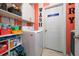 Laundry room with white cabinets, modern washer, and decorations at 642 Nardello Dr, Deltona, FL 32725