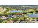 An aerial view of a residential neighborhood surrounded by serene lakes and lush trees, enhancing the community's charm at 6799 Helmsley Cir, Windermere, FL 34786
