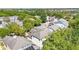 Aerial view showcasing the neighborhood's layout and surrounding trees at 6799 Helmsley Cir, Windermere, FL 34786