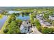 An aerial view of a neighborhood that displays homes nestled among verdant trees and serene ponds at 6799 Helmsley Cir, Windermere, FL 34786