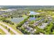 Aerial view of the home situated near a serene lake and lush greenery at 6799 Helmsley Cir, Windermere, FL 34786