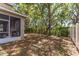 Shaded backyard with mature trees and a screened-in porch at 6799 Helmsley Cir, Windermere, FL 34786