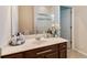 Cozy bathroom vanity with single sink, mirror, and view of shower at 6799 Helmsley Cir, Windermere, FL 34786