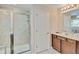 Bright bathroom featuring a glass-enclosed shower and vanity with a single sink at 6799 Helmsley Cir, Windermere, FL 34786