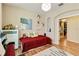 Bedroom featuring wood-look floors, a piano, and an arched doorway at 6799 Helmsley Cir, Windermere, FL 34786