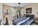 Bright bedroom with bed, a large mirror and drum art at 6799 Helmsley Cir, Windermere, FL 34786