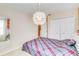 Cozy bedroom featuring a modern light fixture and double door closet at 6799 Helmsley Cir, Windermere, FL 34786