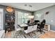 Modern dining room with a stylish light fixture, a dark wood table, and comfortable white chairs at 6799 Helmsley Cir, Windermere, FL 34786